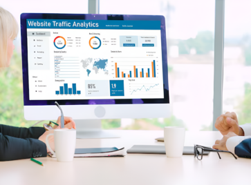 Executives reviewing analytics dashboards illustrating data-driven decision paralysis in modern organizations