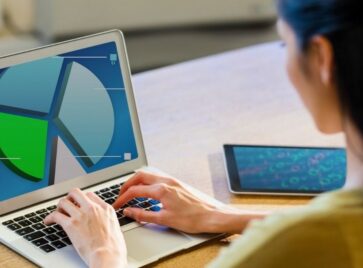Professional analyzing dashboard on laptop illustrating data lifecycle management from data collection to business insights