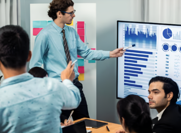 Team analyzing dashboards during strategy meeting illustrating the data talent gap in modern data strategy execution