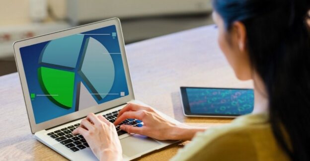 Professional analyzing dashboard on laptop illustrating data lifecycle management from data collection to business insights