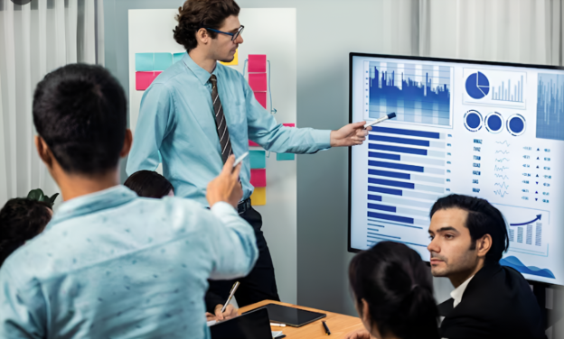 Team analyzing dashboards during strategy meeting illustrating the data talent gap in modern data strategy execution
