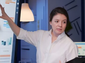 Professional presenting analytics dashboard illustrating the need for a data obsolescence strategy in evolving data systems