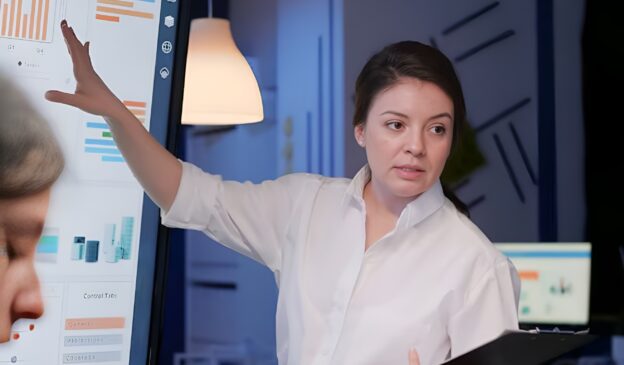 Professional presenting analytics dashboard illustrating the need for a data obsolescence strategy in evolving data systems