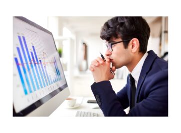 Business professional analyzing charts on a screen representing B2B data procurement and data source evaluation