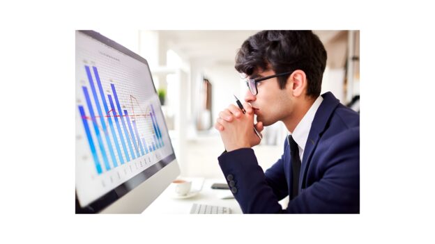 Business professional analyzing charts on a screen representing B2B data procurement and data source evaluation