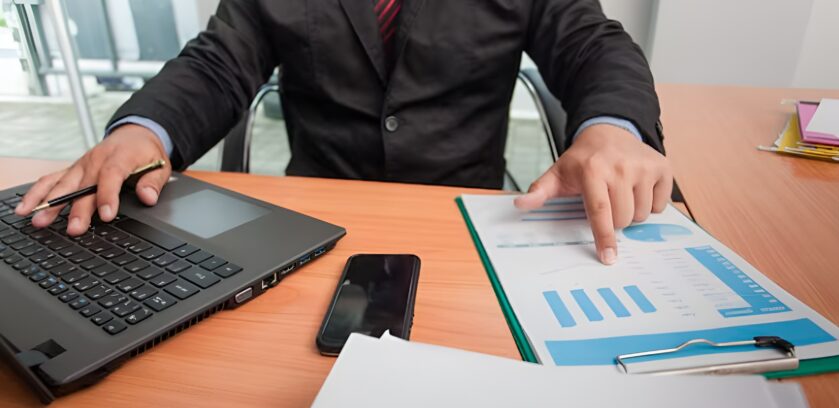 Professional reviewing multiple data records and reports illustrating identity resolution B2B challenges with fragmented accounts
