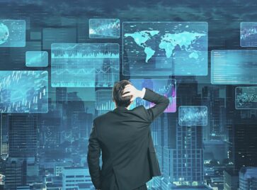 Business professional analyzing multiple dashboards and analytics screens to transform raw information into actionable data context for GTM intelligence