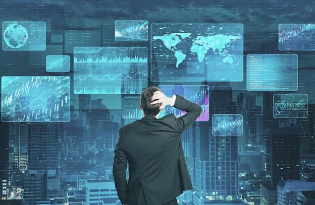 Business professional analyzing multiple dashboards and analytics screens to transform raw information into actionable data context for GTM intelligence