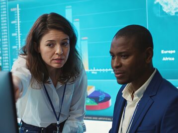 Business professionals reviewing analytics dashboards and performance metrics to improve data-driven decision making across teams