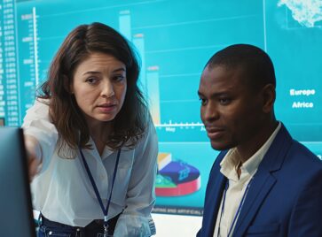 Business professionals reviewing analytics dashboards and performance metrics to improve data-driven decision making across teams