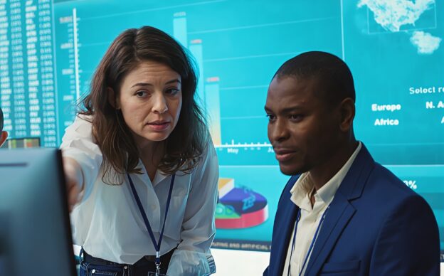 Business professionals reviewing analytics dashboards and performance metrics to improve data-driven decision making across teams