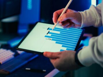 Professional analyzing visual analytics on a tablet as part of a B2B data interpretation framework for business decision-making