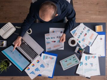 Business professional reviewing dashboards and reports to improve B2B data prioritization and identify high-value GTM signals