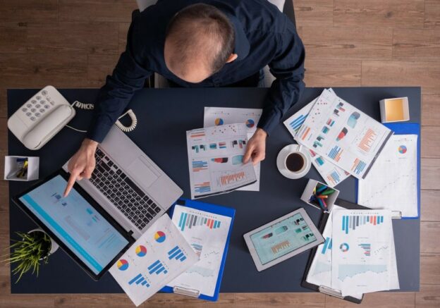 Business professional reviewing dashboards and reports to improve B2B data prioritization and identify high-value GTM signals