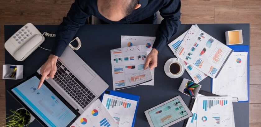 Business professional reviewing dashboards and reports to improve B2B data prioritization and identify high-value GTM signals